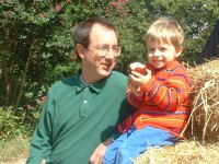 Boy with apple in autumn