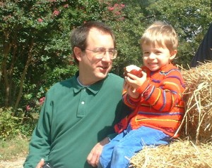 Boy with apple in autumn